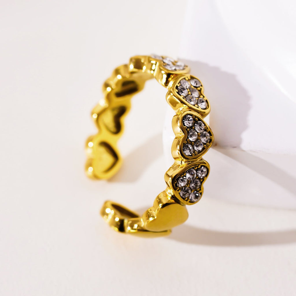 JEZREEL: Heart-Shaped Mini Charms Encircled Ring With Zirconia Crystal Centre Pieces