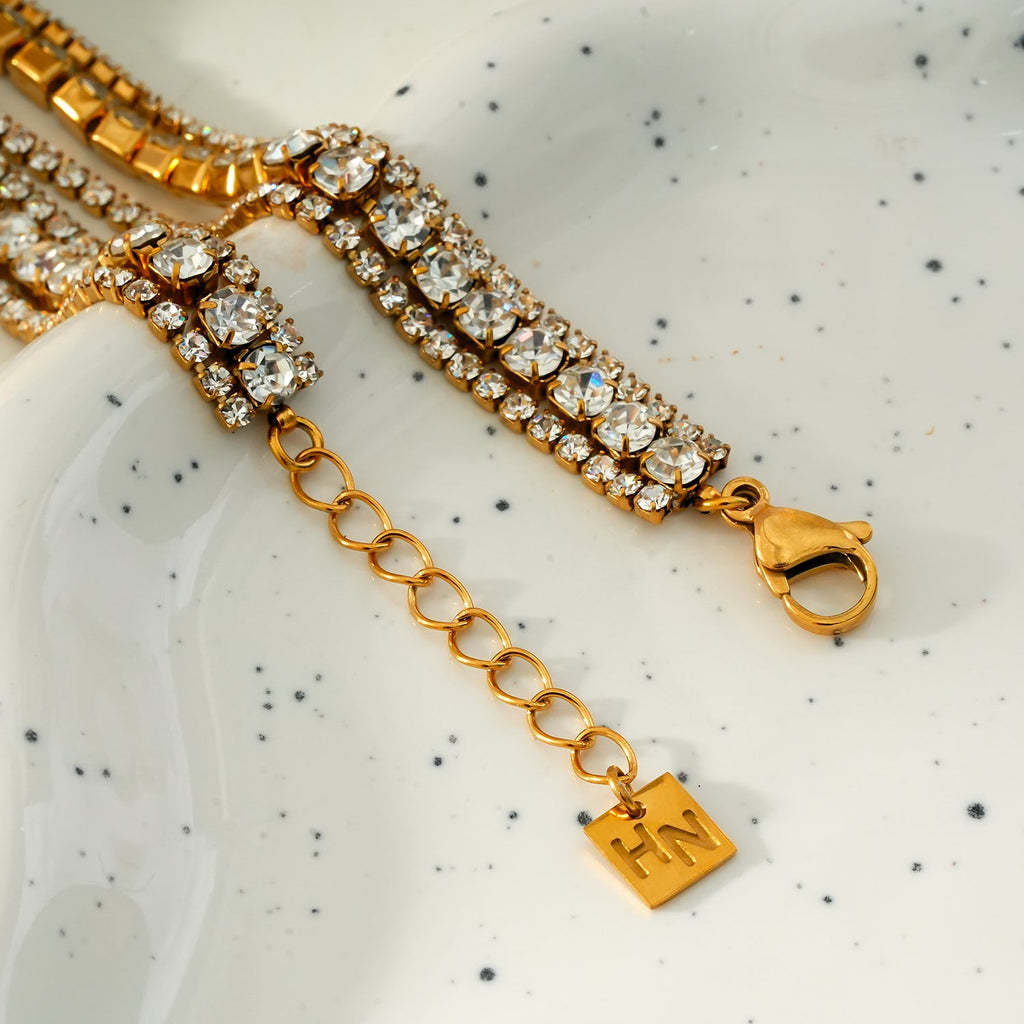 NANDAMA Gold: Triple Layered - Three-Row Zirconia (CZ) Tennis Bracelet with Bold Centerpiece. Stacked for Glamour.